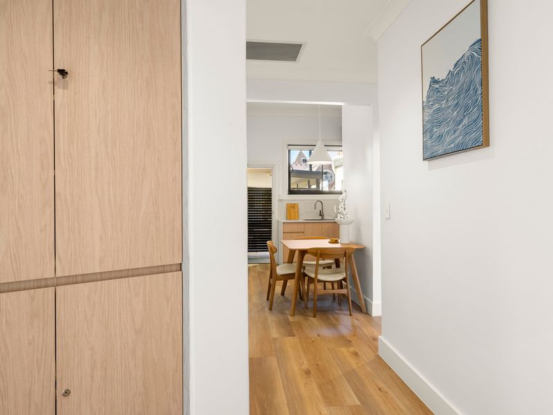 Hallway connecting the bedroom with the living and dining spaces.