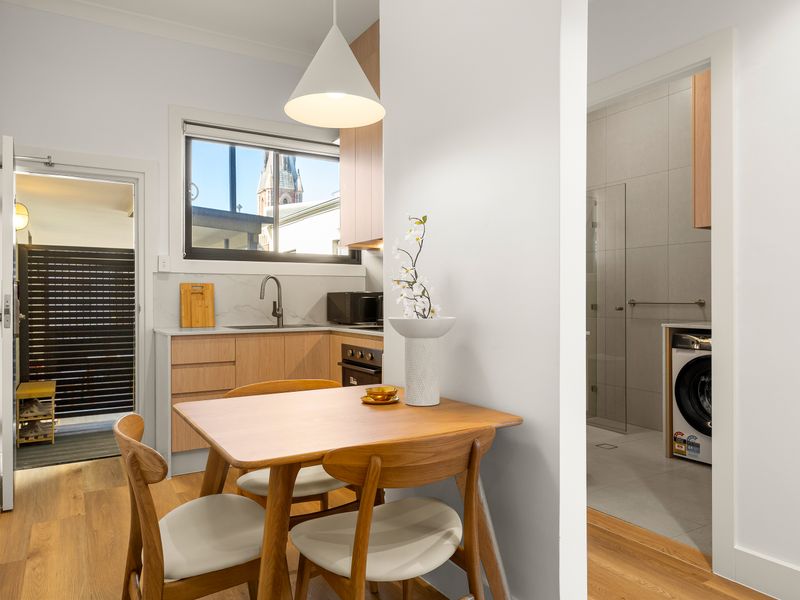 Dining area conveniently positioned beside the kitchen and entryway.
