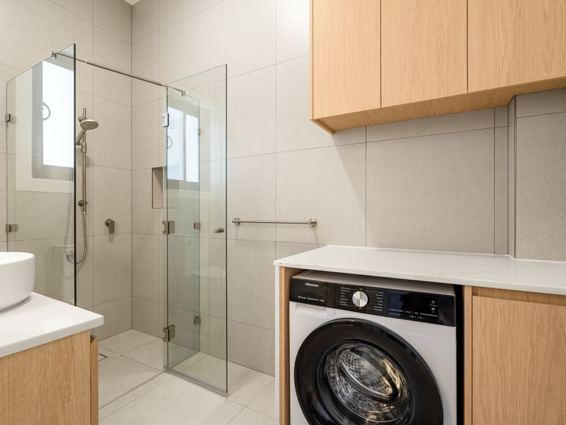 Bathroom with integrated laundry including washer and dryer.