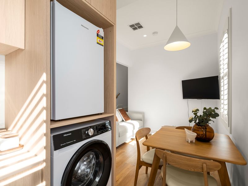 Kitchen with integrated laundry including washer and dryer.