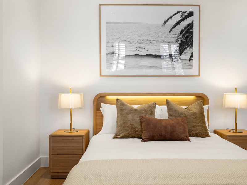 Plush queen bed with bedside lighting for restful nights.