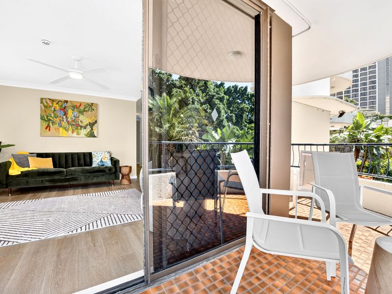 Private balcony with outdoor seating and lush views.