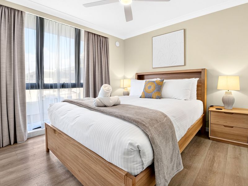 Comfortable bedroom with soft furnishings and natural light