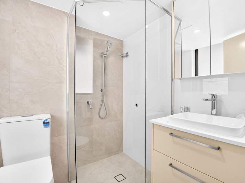 Sleek, modern bathroom with a walk-in glass shower.