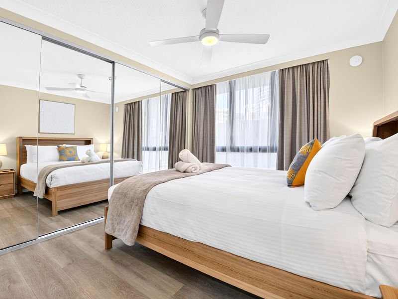 Cozy and bright bedroom with a plush queen bed.
