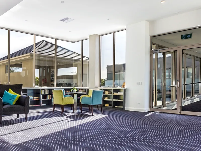 Sun-filled communal lounge with outdoor access