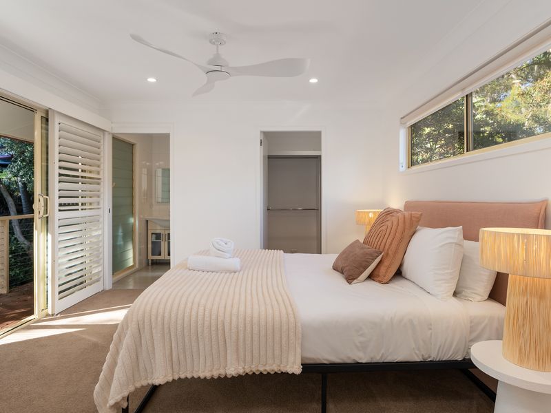 Peaceful king bedroom with leafy views and direct outdoor access