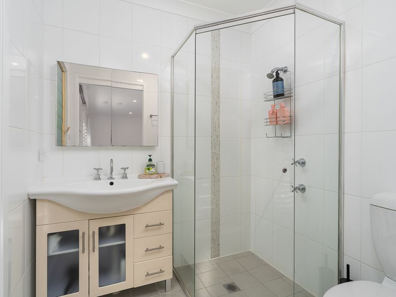 Convenient bathroom with walk-in shower and modern vanity