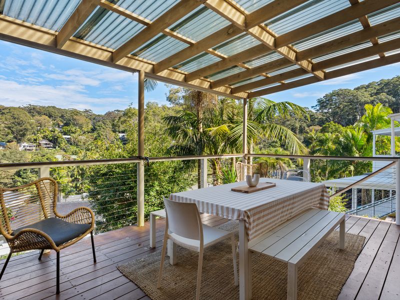Relax on the covered balcony surrounded by lush North Avoca greenery