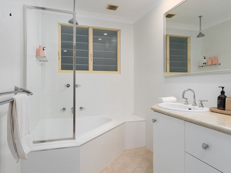 Bright family bathroom with combined bath and shower