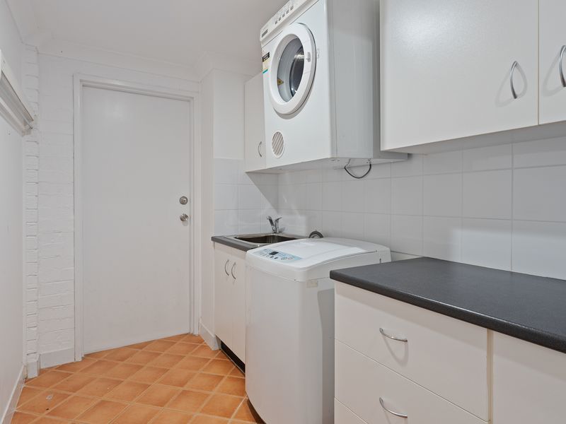 Full internal laundry with washing machine and storage