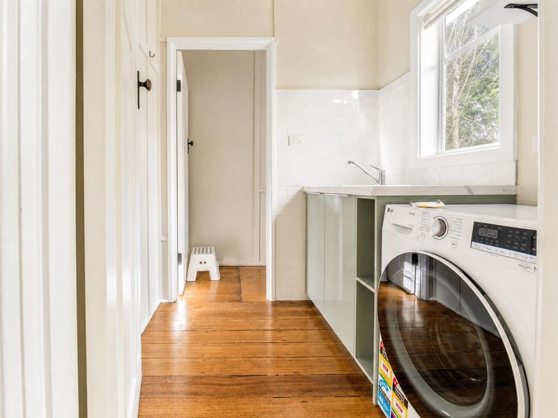 Convenient laundry nook with a washing machine and storage.