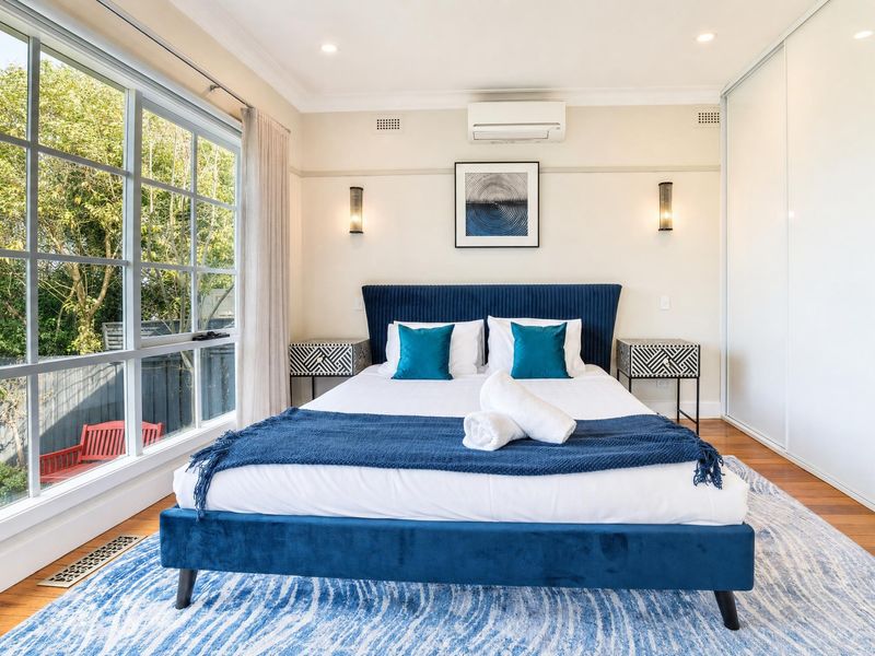 Close-up of the comfortable blue-accented main bed.