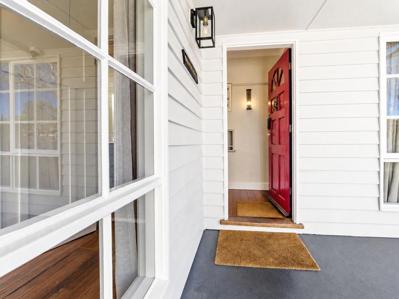 Welcoming front entryway with a vibrant red door.