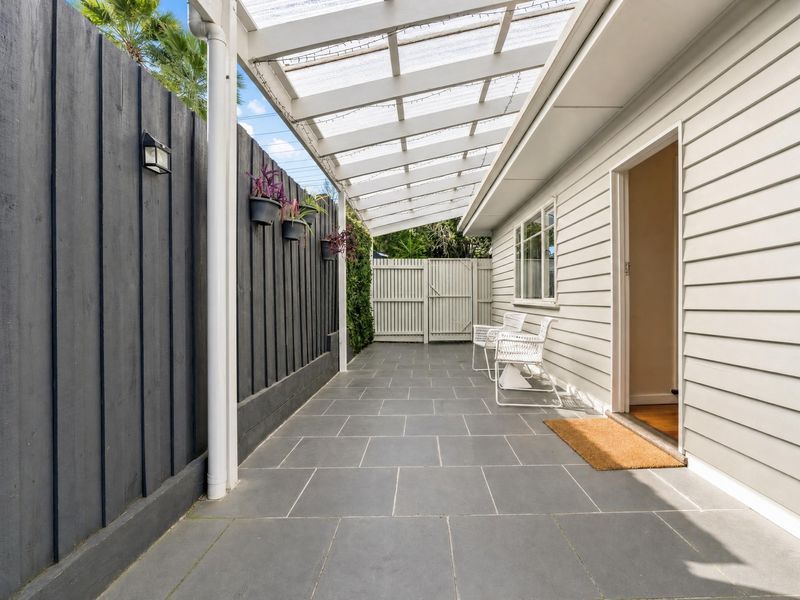 Covered outdoor walkway along the side of the house.