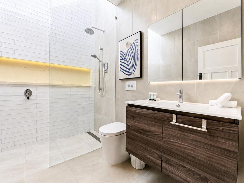 Modern bathroom with a stylish vanity and walk-in shower.