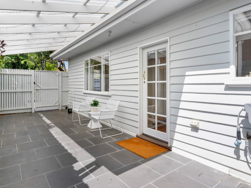 Covered outdoor walkway along the side of the house.