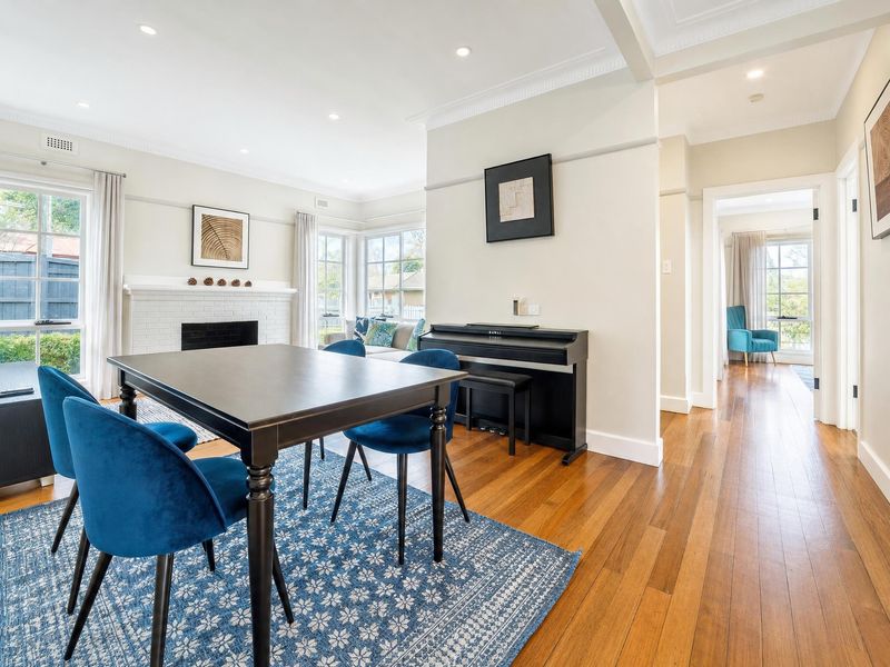 Open-plan dining and kitchen area with hardwood floors.