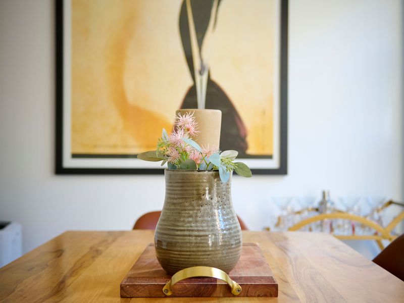 Elegant dining space featuring a centerpiece vase on the table.