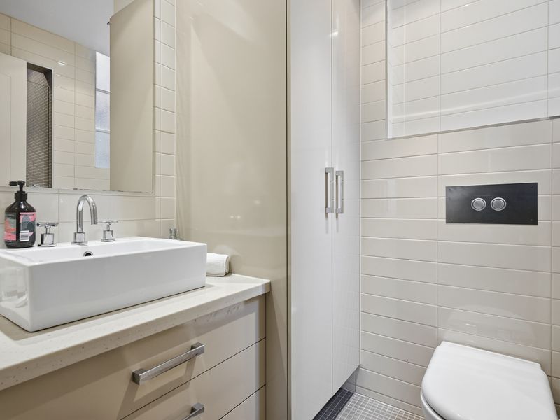 Contemporary bathroom vanity with a clean white basin.