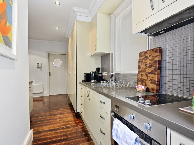 Compact and functional kitchen featuring a built-in cooktop.