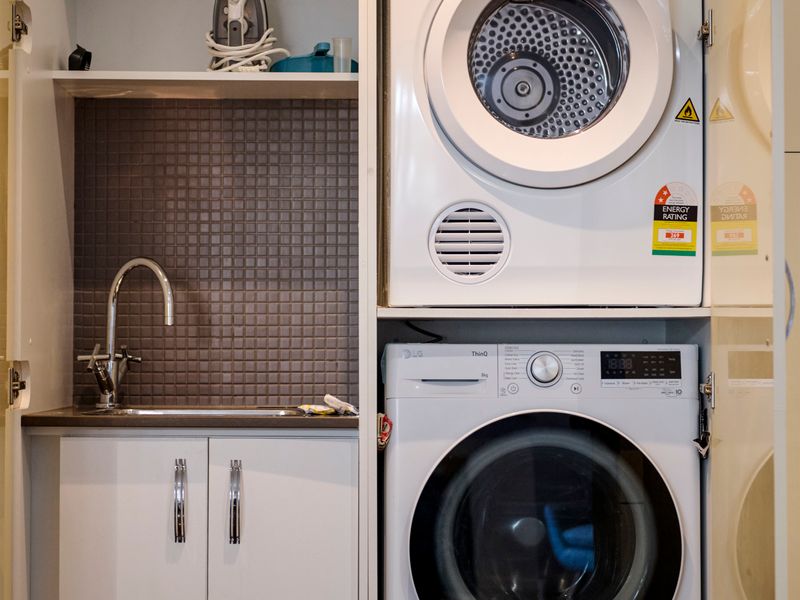 Compact laundry nook equipped with a washing machine and dryer.