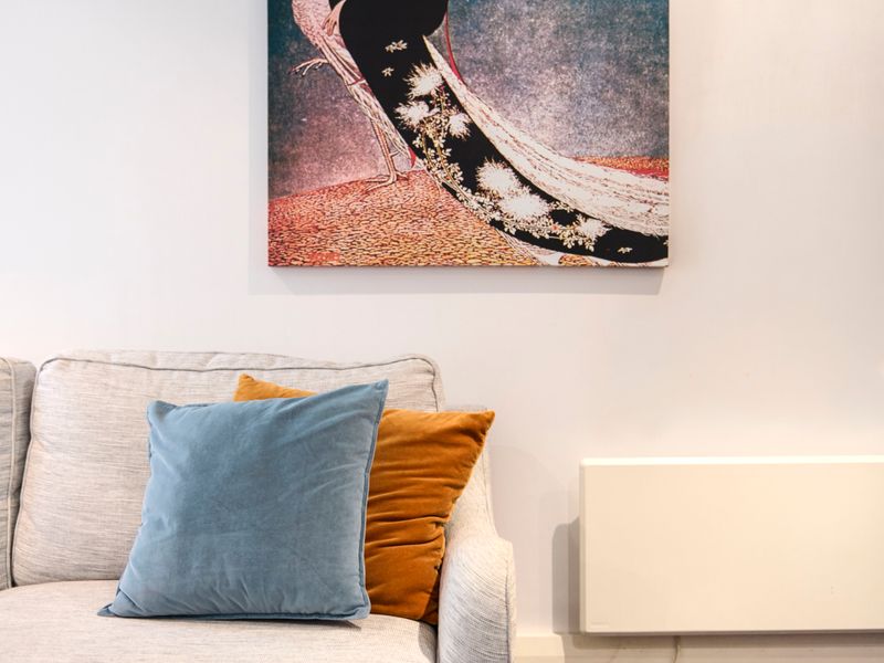 Close-up of comfortable seating cushions and wall art decor.