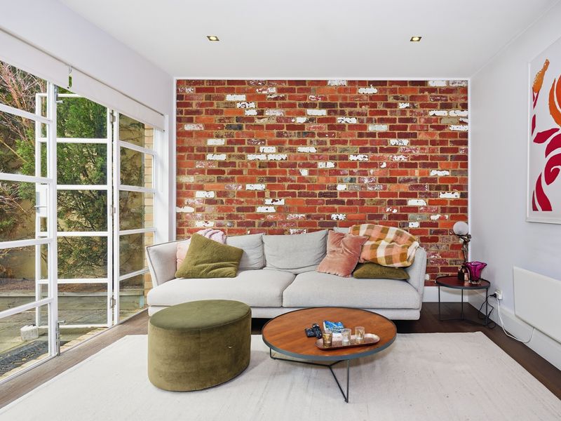 Relaxing lounge space with natural light streaming through expansive windows.