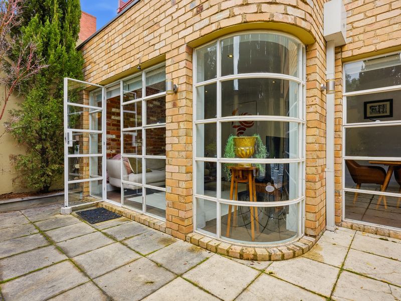 Scenic view of the brick exterior and large curved windows from the patio.