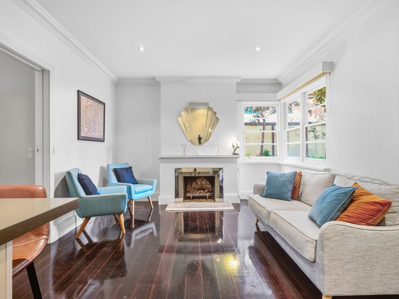 Bright and inviting living room layout with comfortable sofa seating.