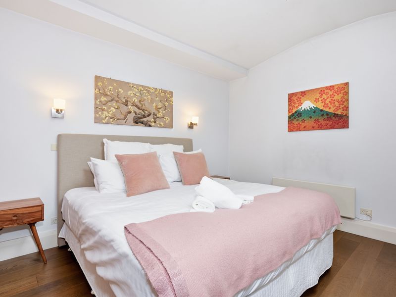 Inviting bedroom setup with colorful wall art.