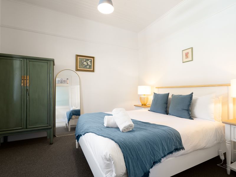 Inviting bedroom with bedside lamps and plenty of natural light