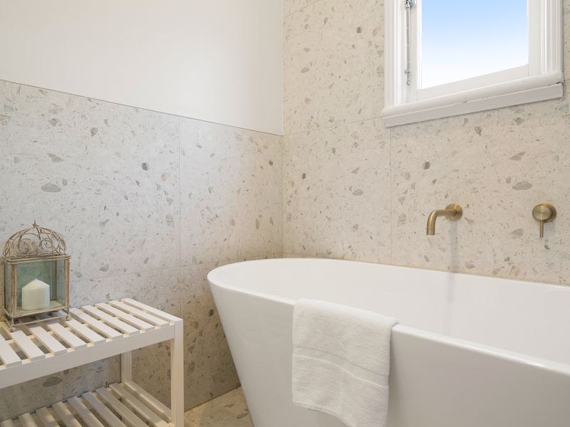 Bright and relaxing bathroom featuring a deep soaking bathtub.