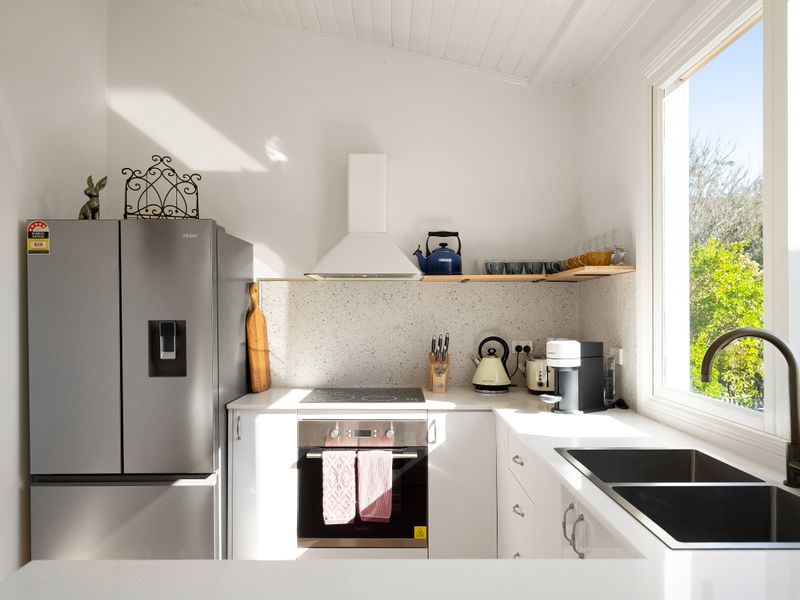 Bright kitchen with leafy views through the windows