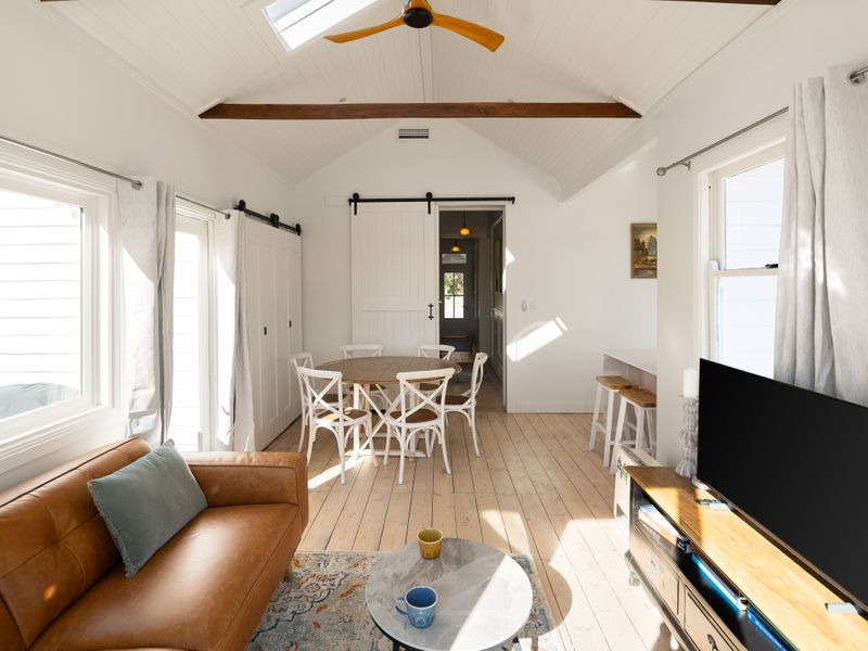 Sun-filled living area flowing through to the dining space