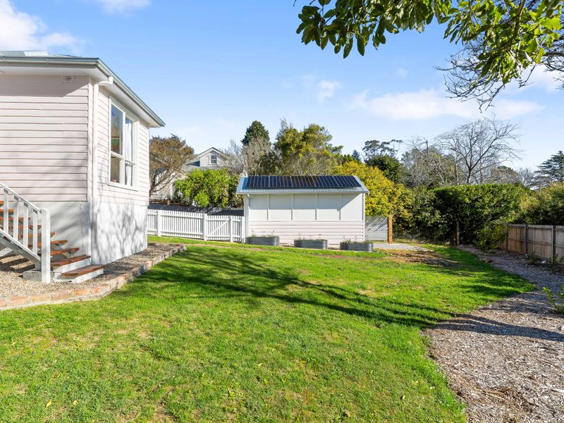 Expansive view of the open backyard and secondary outdoor shed structure.