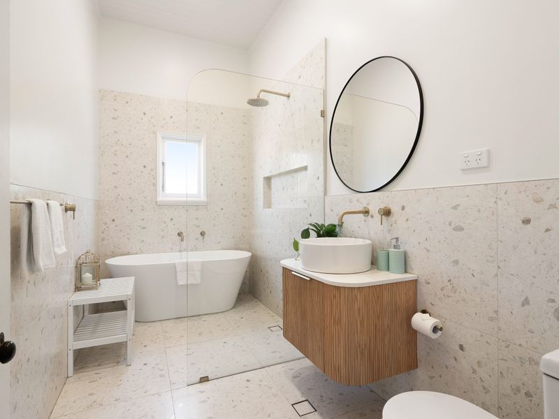Wide view of the modern bathroom setup including the vanity and tub.