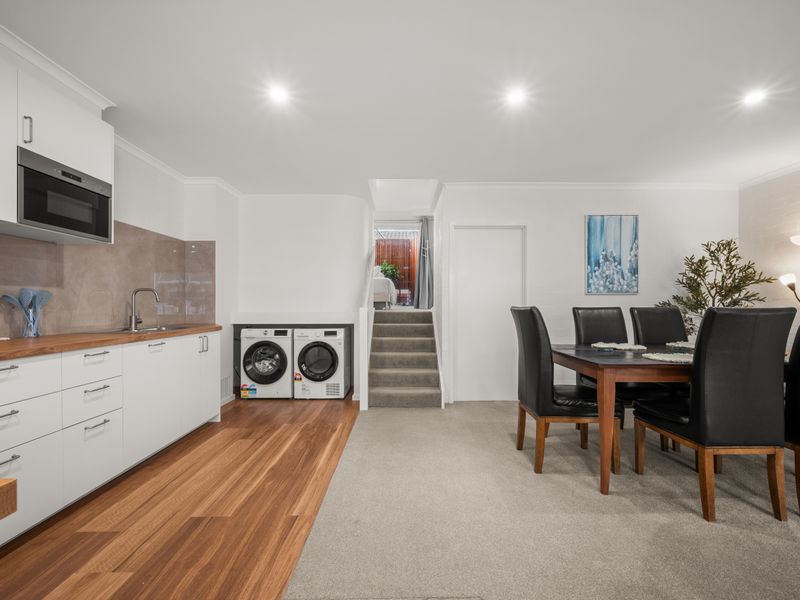Kitchen layout showing the integrated laundry setup with washing machines.