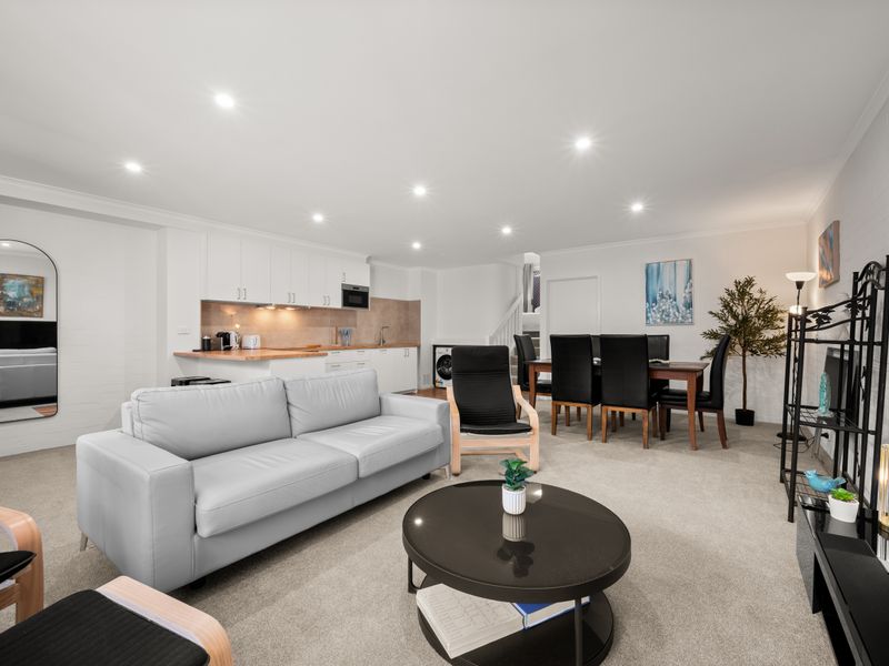 Modern open-plan living and kitchen area from another angle.