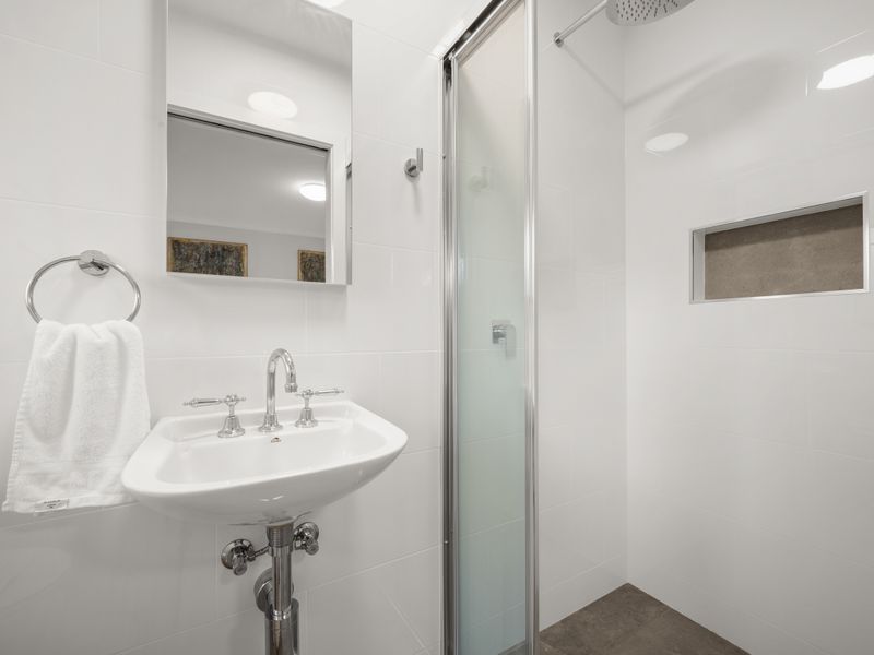 Clean bathroom vanity and sink area with a wall mirror.
