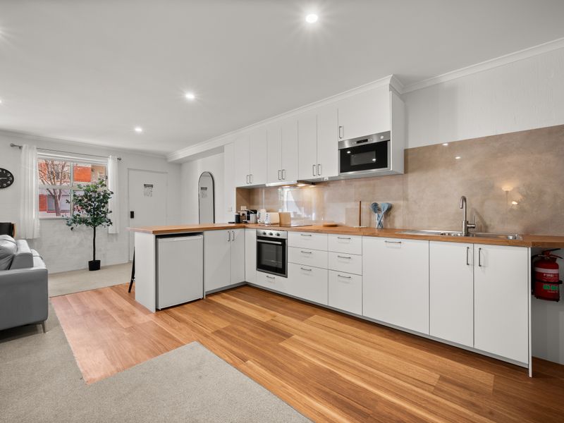 Kitchen and dining layout showcasing the full counter length.