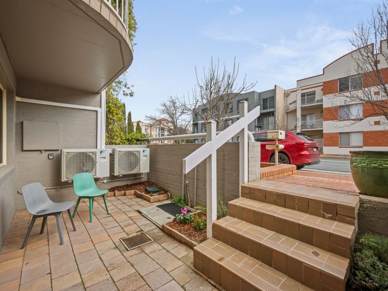 Private outdoor patio area with steps and garden seating.