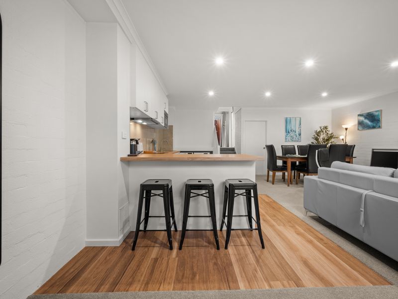 Kitchen counter and island view with bar stools.