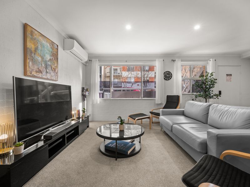 Living room setup featuring a flat-screen TV and coffee table.