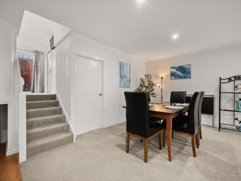 Indoor dining area set against a clean white wall.