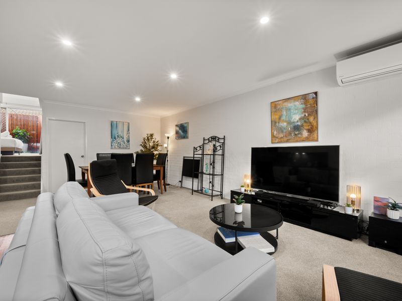 Living area entertainment setup with a couch and television.