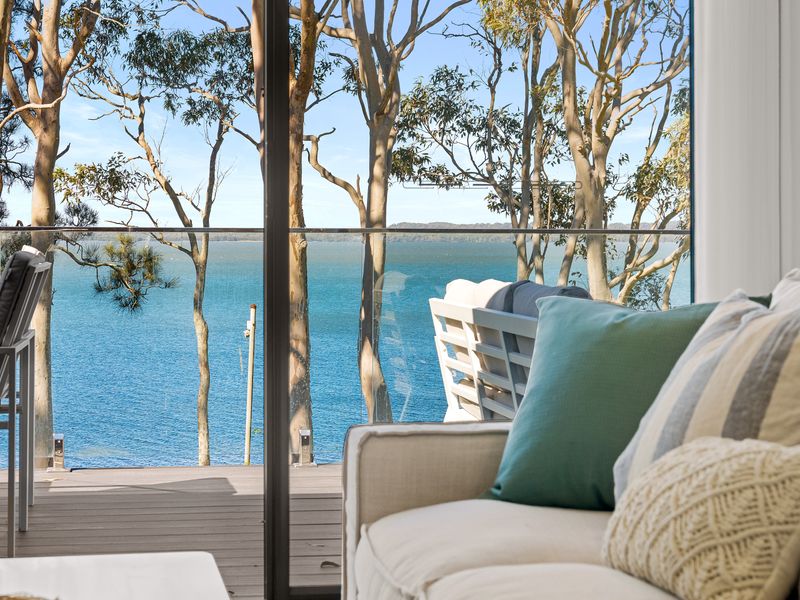 Open living from lounge to balcony with water views