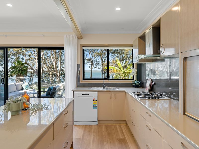 Open plan kitchen with appliances and water views