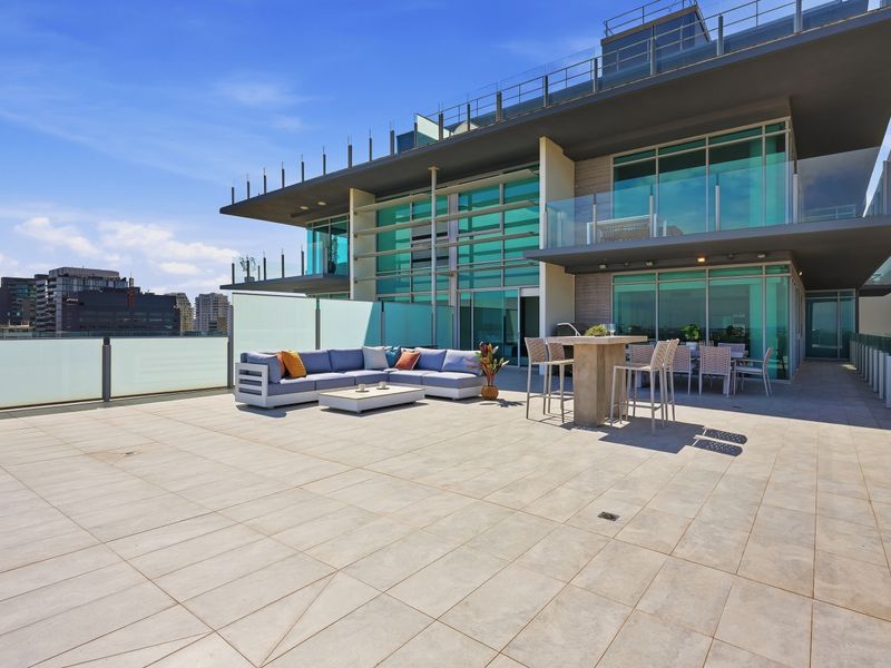Private rooftop retreat with luxurious seating and endless sunshine.