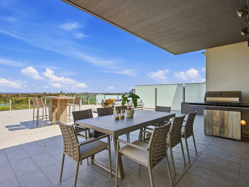 Expansive rooftop terrace with outdoor dining and stunning open-sky views.